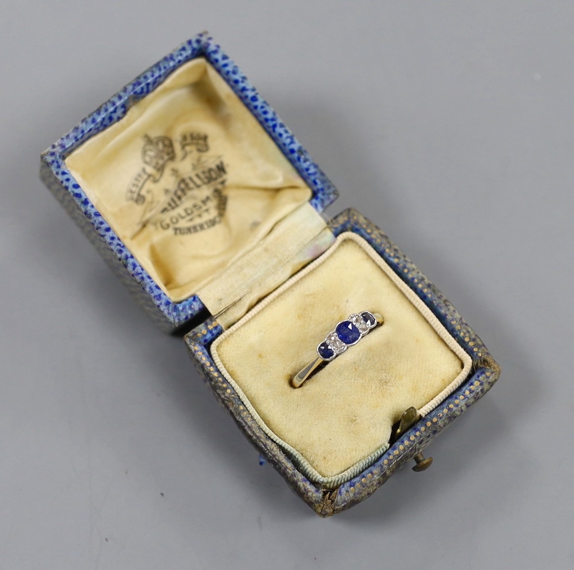 A 1920's 18ct and plat, three stone sapphire and four stone diamond chip set ring, size O, gross weight 1.9 grams.